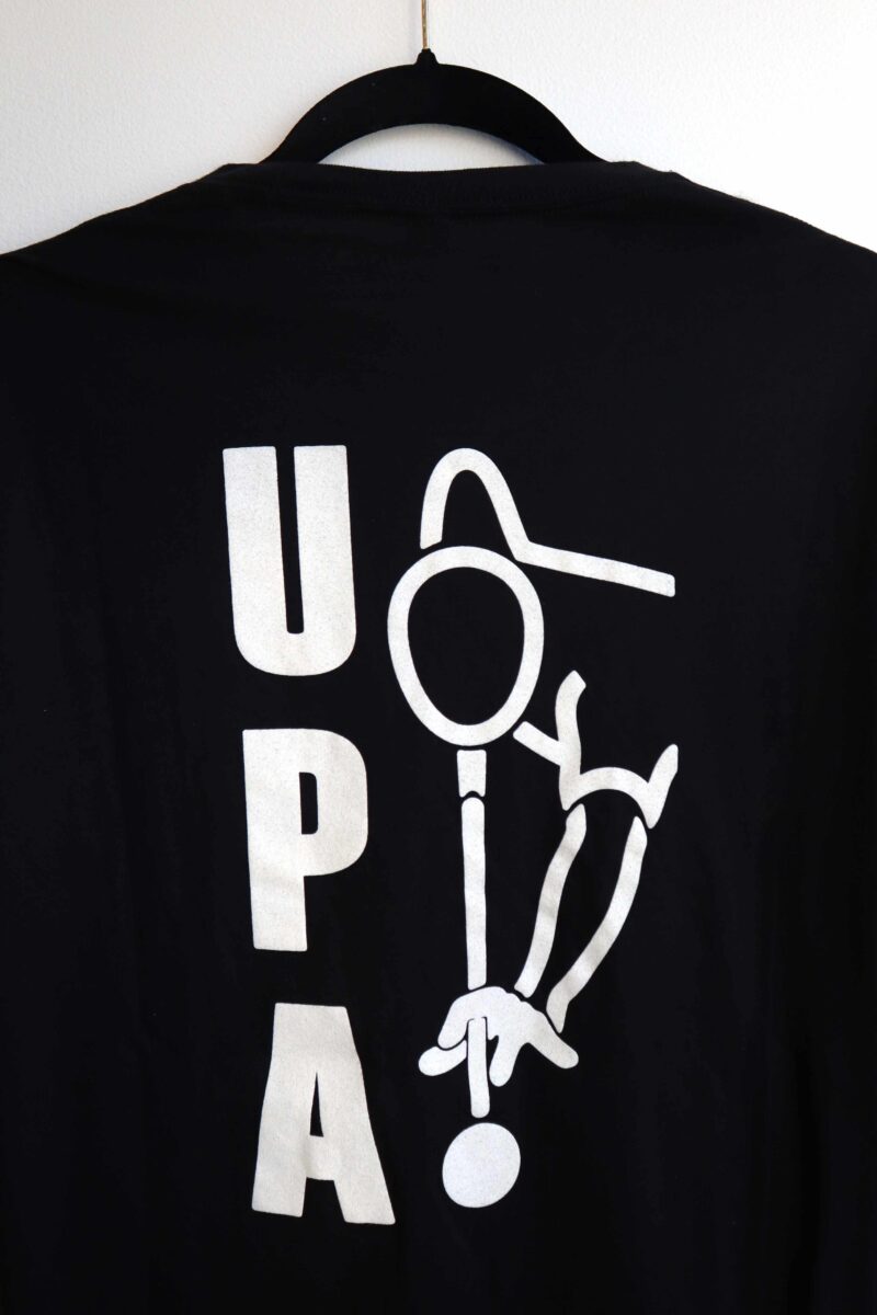 Showing the back of the Ladies Evolve Your Game T-shirt with the letters UPA and logo in white