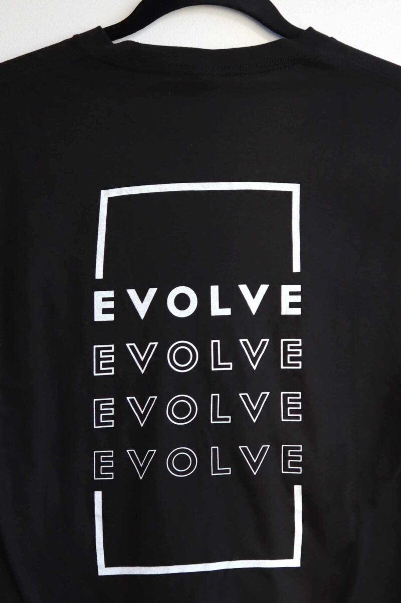 Design on the back of the Evolve - Unisex Concert Tee. Repeating Evolve in a white rectangle design